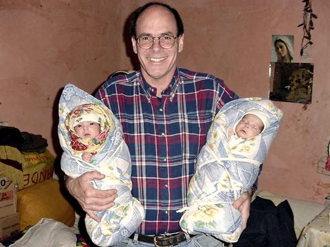 John Fenlason with two newborns, bundled against the cold, November 2001