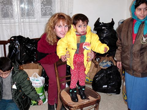 Suzanne Fenlason with a little boy in his new winter snowsuit