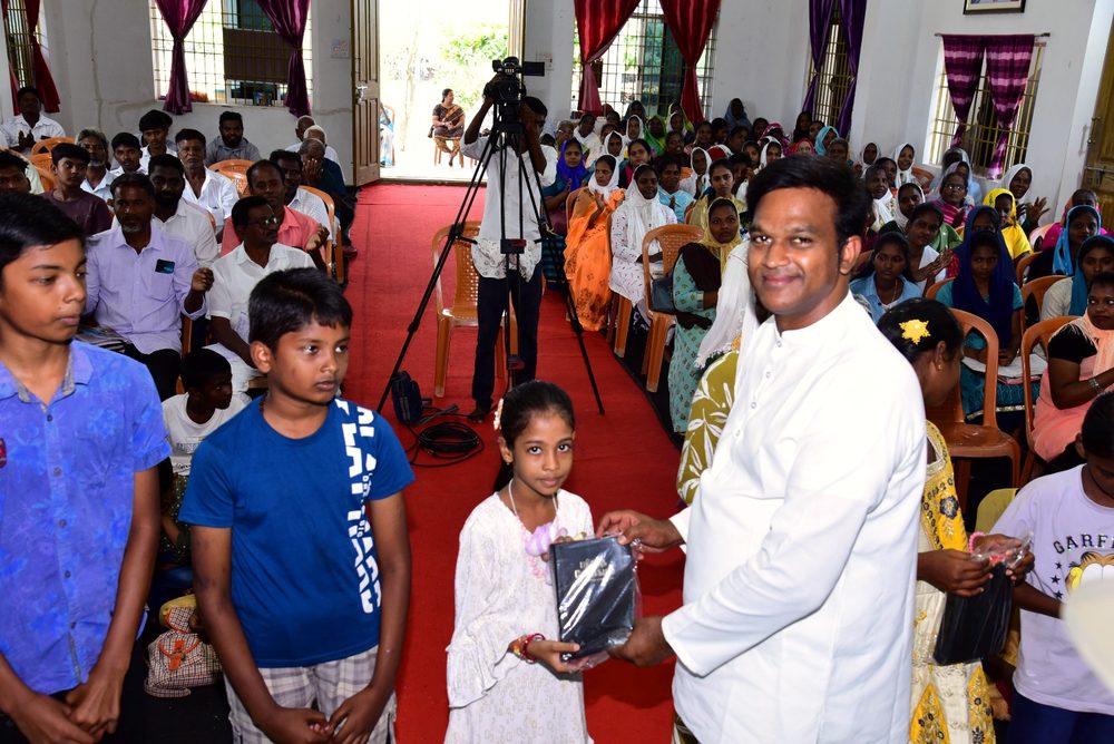 A child receives a Bible at Vacation Bible School