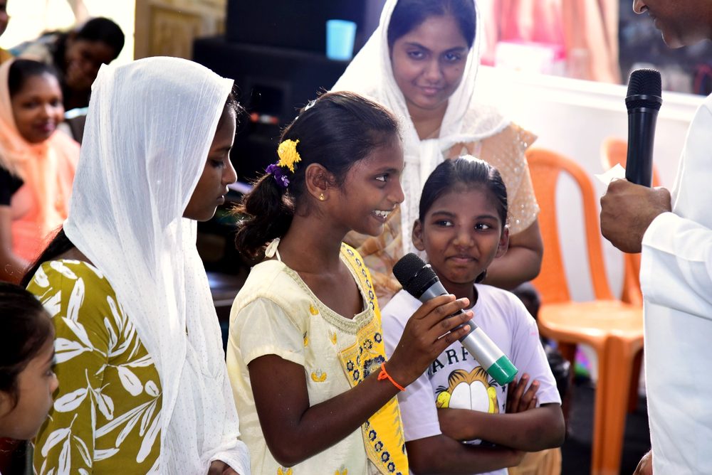 A girl speaks at Vacation Bible School