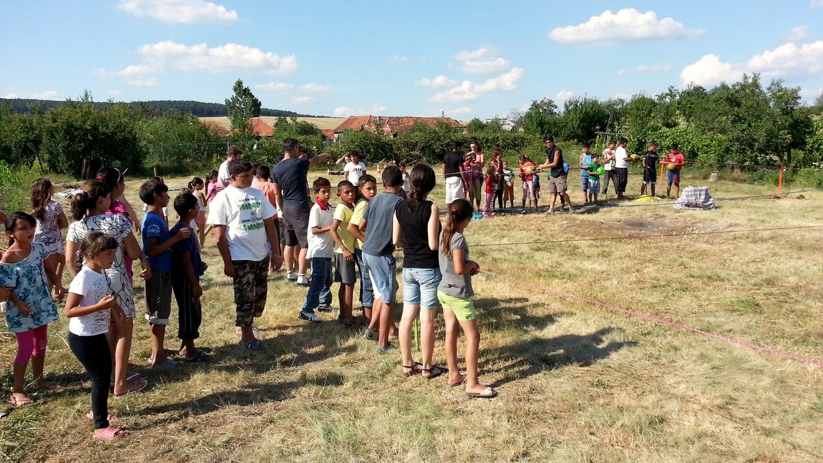 Children running across the summer camp field in Lazareni, Romania